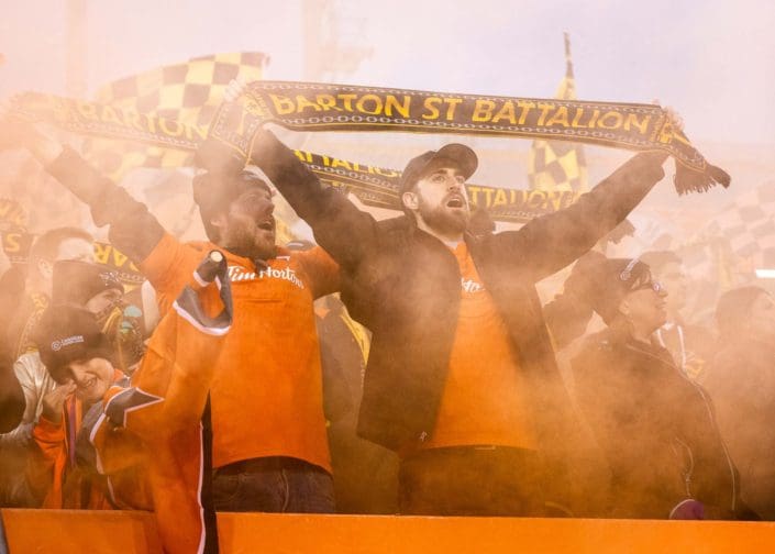 HAMILTON, ON - OCT. 26, 2019: Forge FC fans celebrate at Tim Hortons Field after a 1-0 win over Cavalry FC in the first leg of the Canadian Premier League Finals.